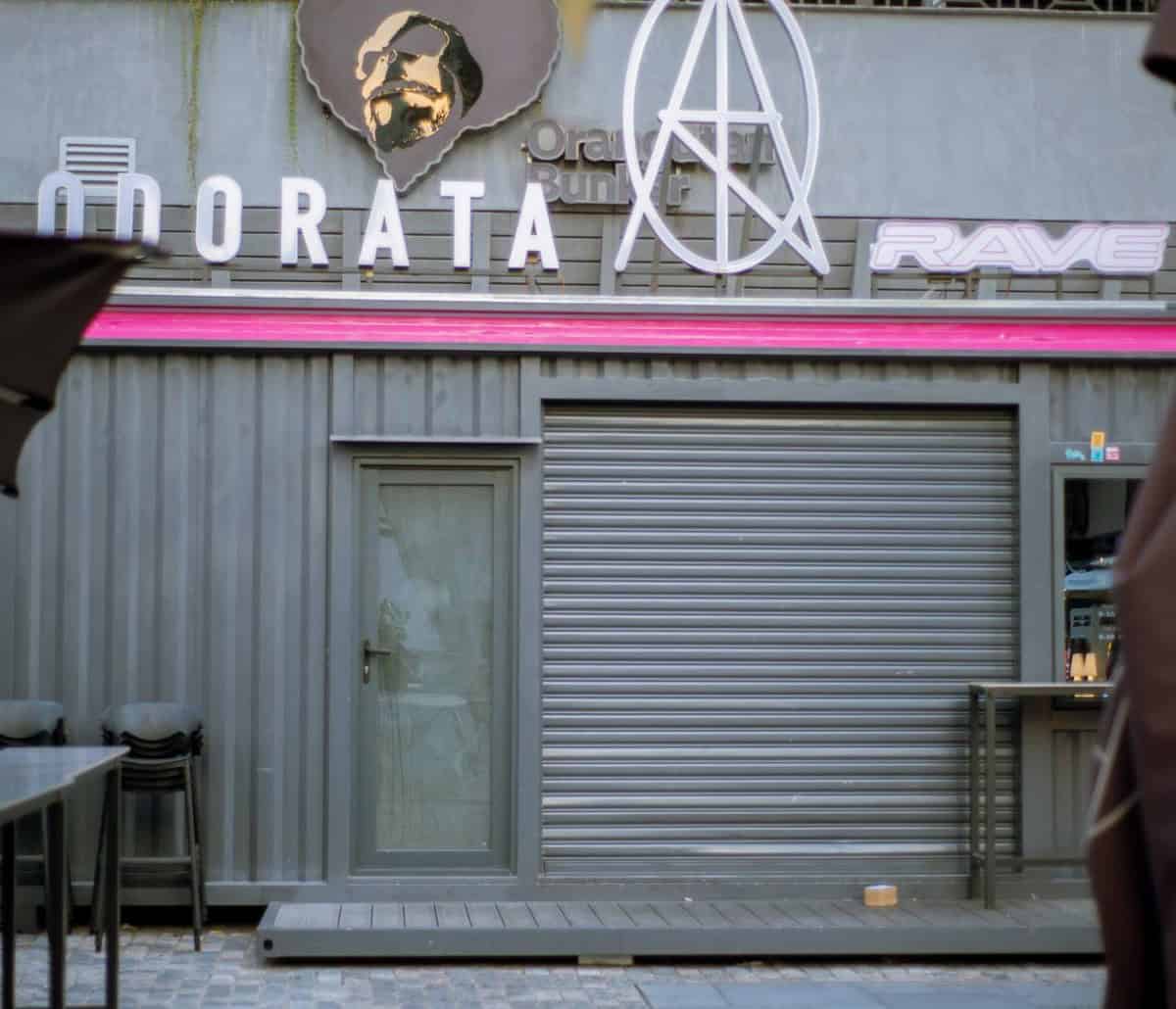 Front of Coco Park with closed shutter, Morata and Rave signage, and stacked chairs — thirstyguide.com