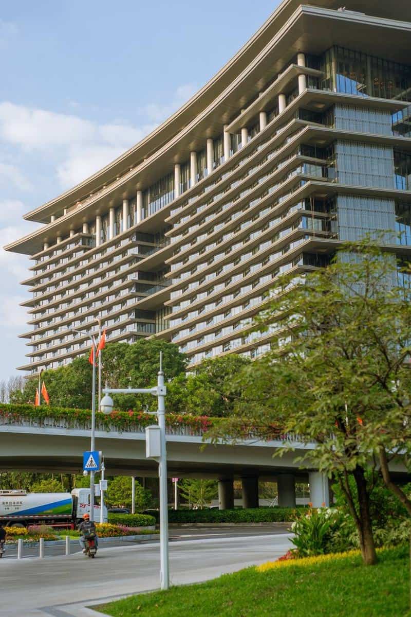 Scooter rider outside a building at 30 Things to Do Before You Come to Shenzhen, China for APEC 2026 — thirstyguide.com