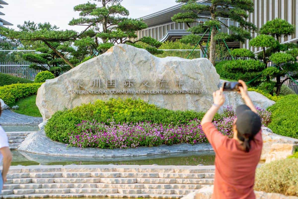 A person photographs a stone at 30 Things to Do Before You Come to Shenzhen, China for APEC 2026 — thirstyguide.com