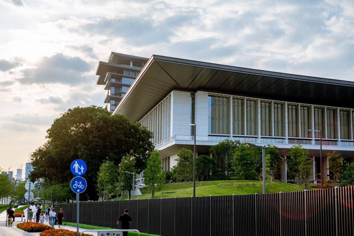 Pedestrians near a modern building at 30 Things to Do Before You Come to Shenzhen, China for APEC 2026 — thirstyguide.com