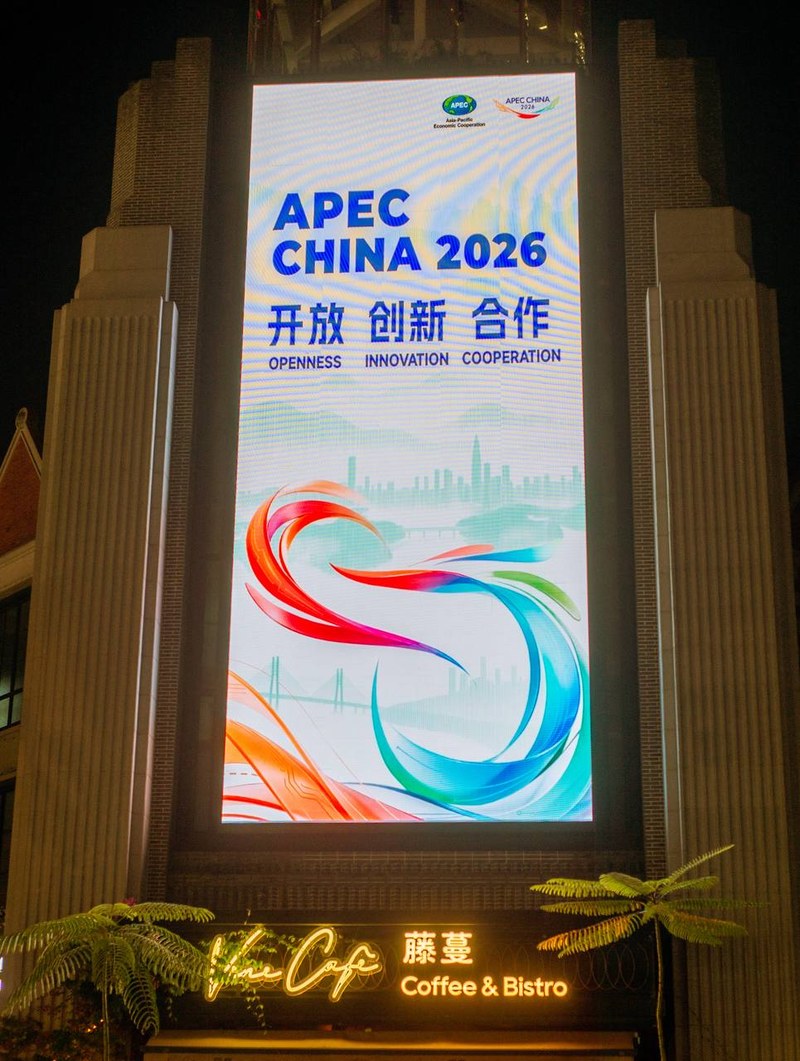 APEC 2026 billboard above Vine Cafe, Shenzhen guide — thirstyguide.com